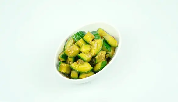 A bowl of smashed cucumber in a garlic, vinegar and chilli-oil dressing